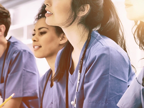 Medical students listening sitting at desk