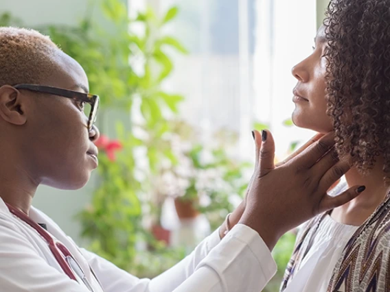 Doctor watching patient with sore throat