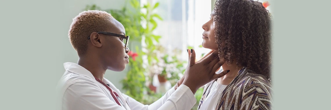 Doctor watching patient with sore throat